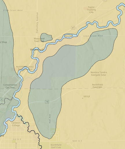 Image depicts close-up section of plat map with shapes filled in with yellow, green, and blue. There is a faint modern-day GPS map visible behind the plat map, with street grids and current landmarks indicated.
